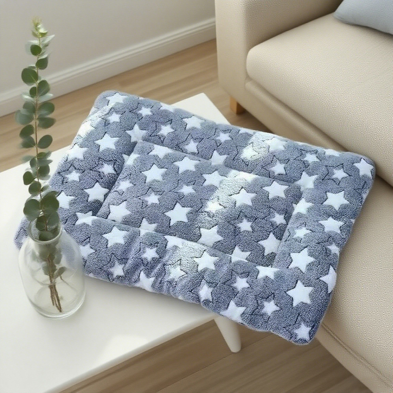 Gray star coral fleece padded pet mat on a side table